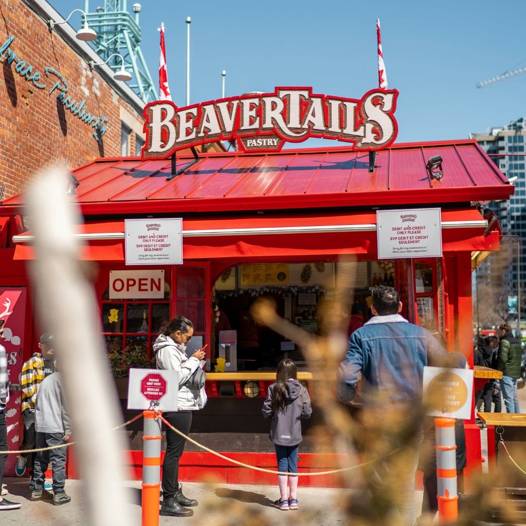 Beaver tail pastries held outdoors in winter.
